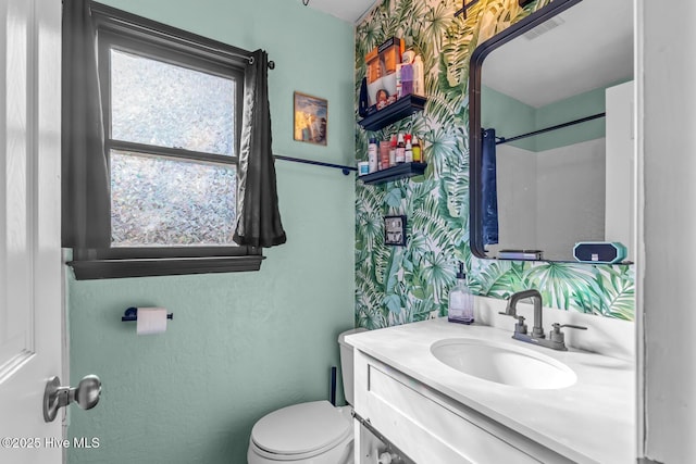 bathroom featuring vanity, a shower with shower curtain, and toilet