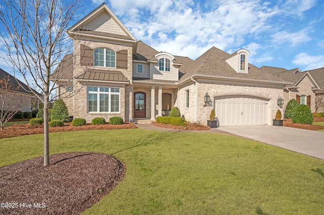 view of front of property featuring a garage and a front yard