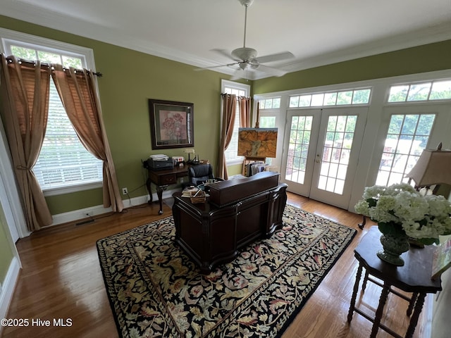 office featuring crown molding, plenty of natural light, light hardwood / wood-style floors, and french doors