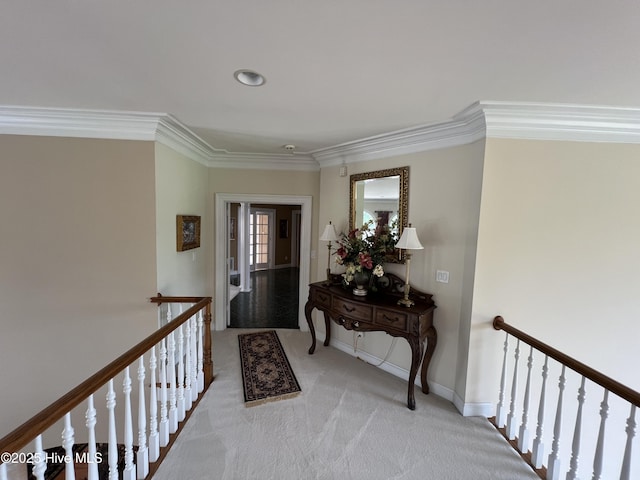 carpeted foyer with ornamental molding