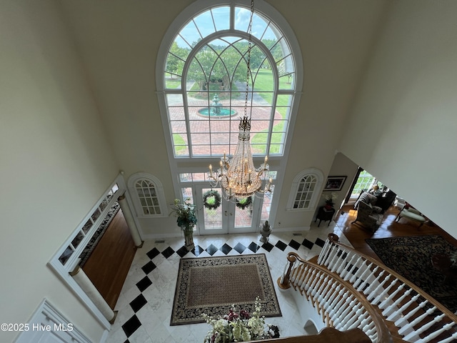 foyer featuring a notable chandelier and a towering ceiling