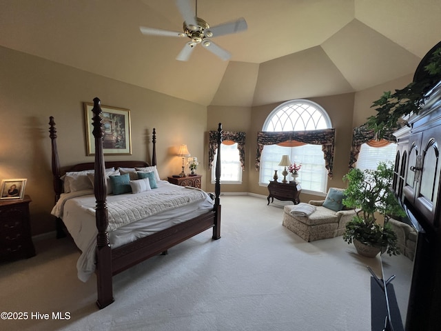 bedroom featuring vaulted ceiling, light carpet, and ceiling fan