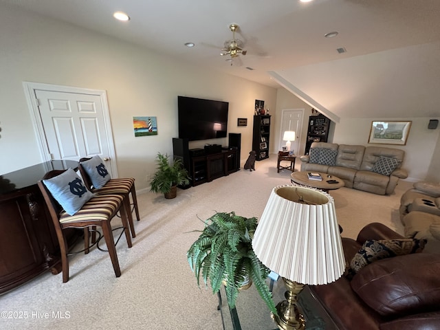 living room with ceiling fan, carpet flooring, and vaulted ceiling