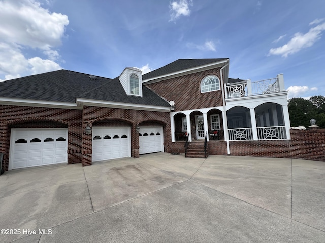 view of front of home with a balcony and a garage