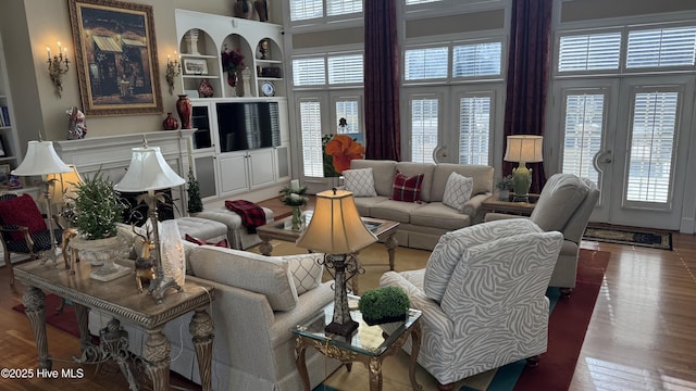 living room featuring french doors, a healthy amount of sunlight, and hardwood / wood-style flooring