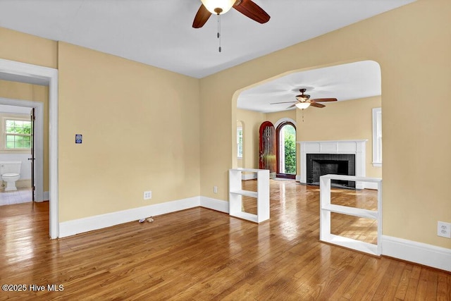 2817 Park Ave, Wilmington, NC 28403 - unfurnished living room with ceiling fan, plenty of natural light, hardwood / wood-style flooring, and baseboards