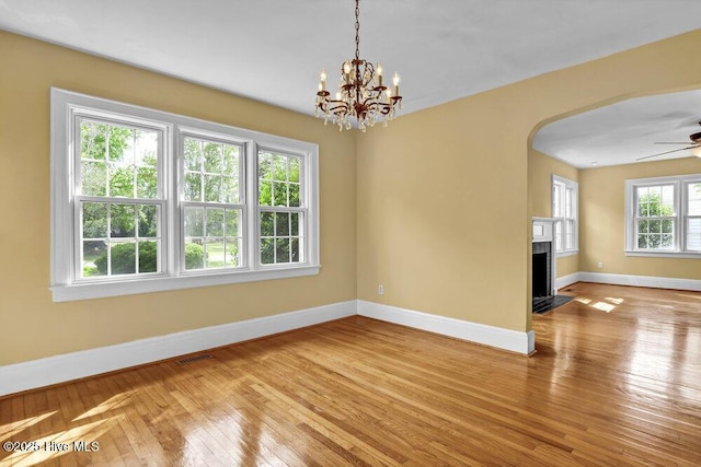 2817 Park Ave, Wilmington, NC 28403 - spare room with baseboards, hardwood / wood-style flooring, a ceiling fan, and arched walkways