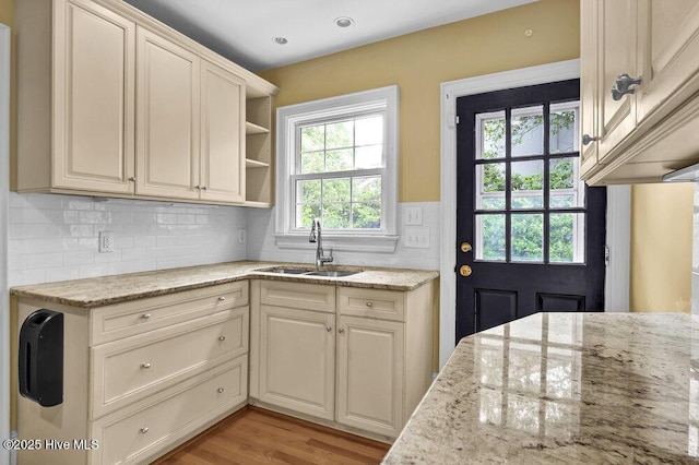 2817 Park Ave, Wilmington, NC 28403 - kitchen with a sink, light stone counters, light wood-style floors, decorative backsplash, and open shelves