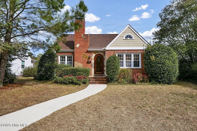 2817 Park Ave, Wilmington, NC 28403 - view of front of house featuring brick siding, a front lawn, a chimney, and roof with shingles