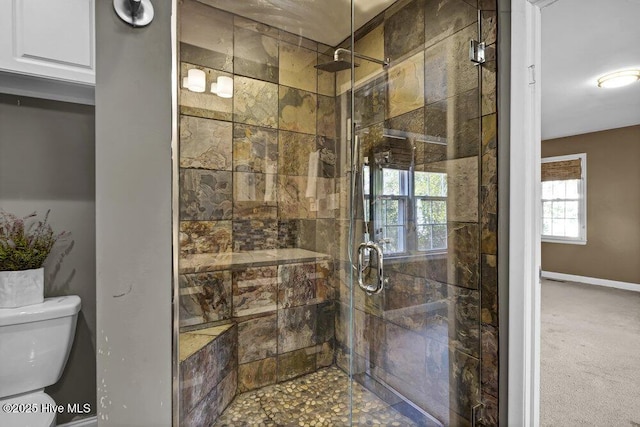 full bathroom featuring baseboards, a shower stall, and toilet