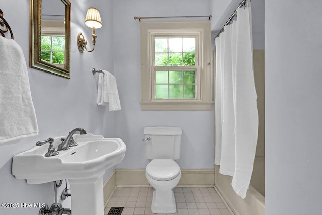 2817 Park Ave, Wilmington, NC 28403 - full bathroom with plenty of natural light, toilet, tile patterned flooring, and baseboards