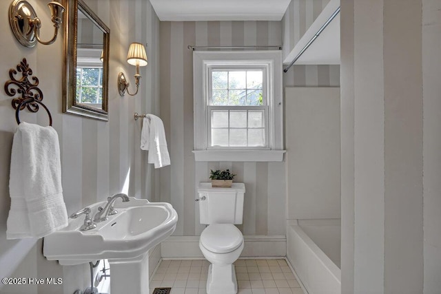 bathroom with a tub to relax in, toilet, tile patterned floors, walk in shower, and wallpapered walls