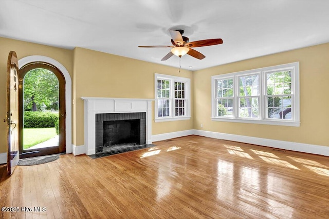 2817 Park Ave, Wilmington, NC 28403 - unfurnished living room featuring wood finished floors, ceiling fan, baseboards, and a brick fireplace