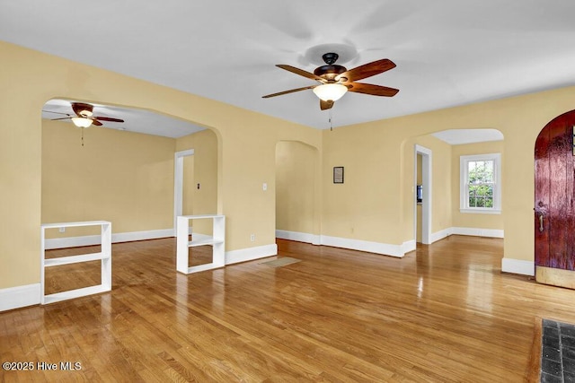 2817 Park Ave, Wilmington, NC 28403 - unfurnished room with ceiling fan, arched walkways, wood finished floors, and baseboards