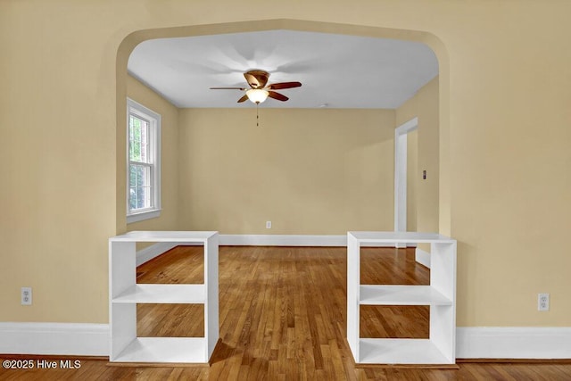 2817 Park Ave, Wilmington, NC 28403 - unfurnished room with arched walkways, a ceiling fan, wood finished floors, and baseboards