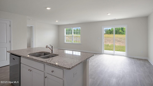 kitchen featuring sink, an island with sink, white cabinets, and dishwasher