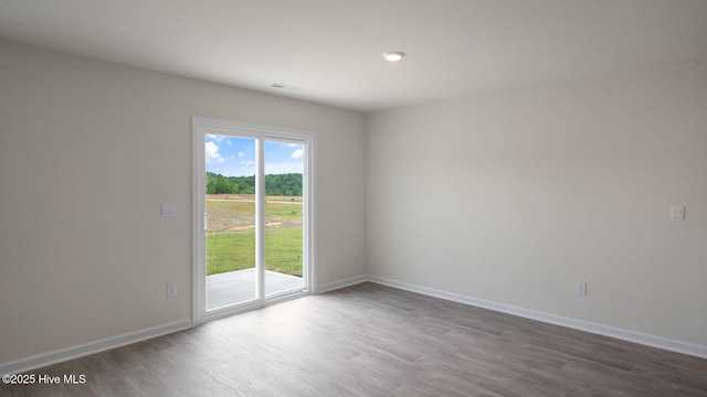 spare room with hardwood / wood-style floors