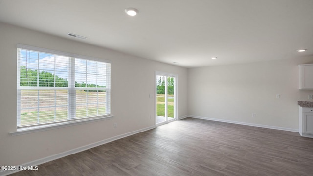 unfurnished living room with dark wood-type flooring