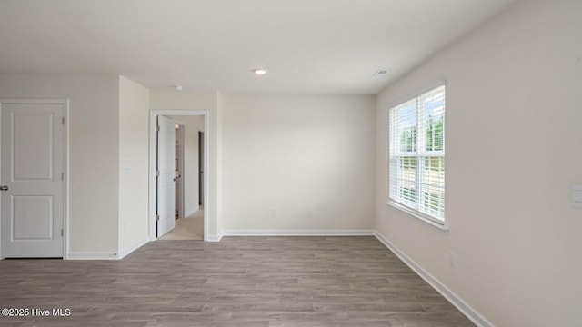 empty room with light hardwood / wood-style flooring