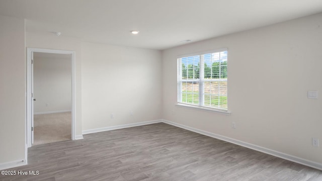 spare room with light hardwood / wood-style flooring