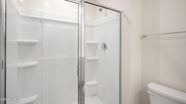 bathroom with toilet and walk in shower