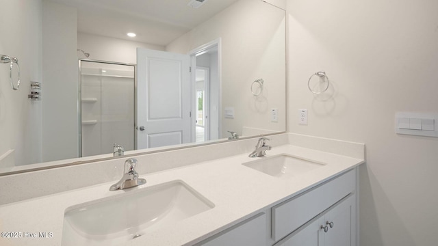 bathroom featuring vanity and an enclosed shower