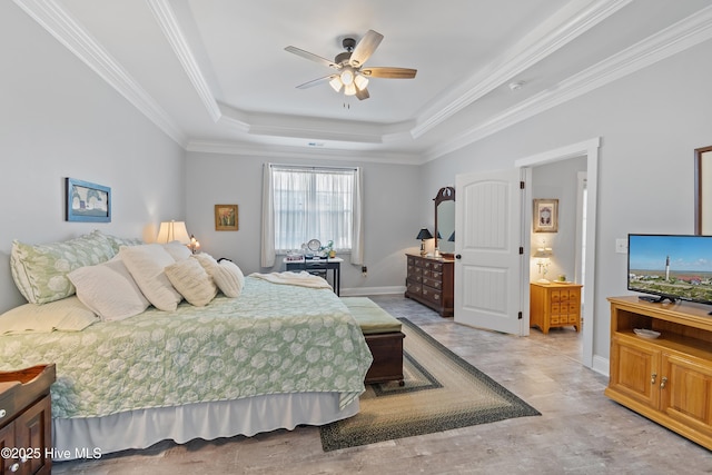 bedroom with ceiling fan, a tray ceiling, baseboards, and ornamental molding