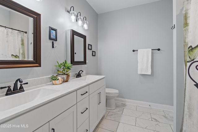 bathroom featuring double vanity, marble finish floor, baseboards, and a sink