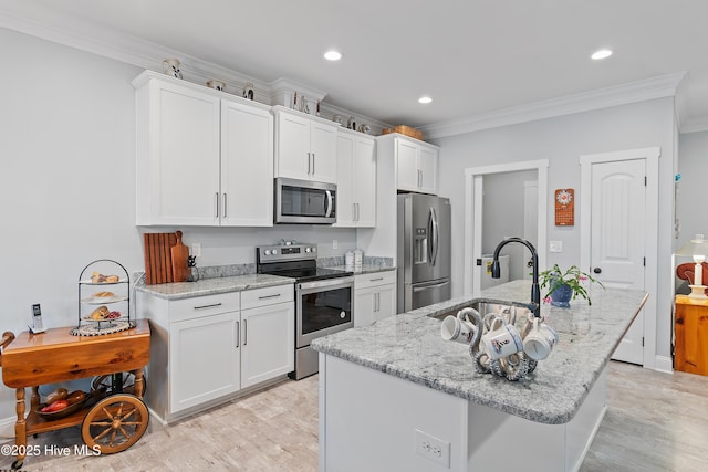 kitchen featuring white cabinetry, ornamental molding, appliances with stainless steel finishes, and a sink