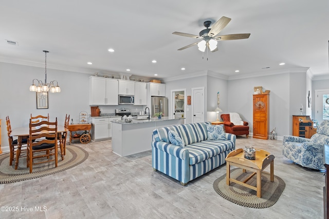 living room with crown molding, recessed lighting, visible vents, and light wood finished floors