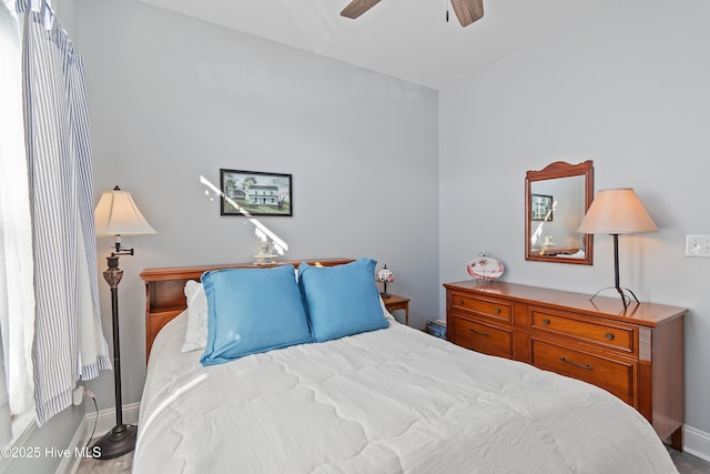 bedroom featuring ceiling fan, baseboards, and vaulted ceiling