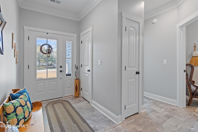 entrance foyer featuring visible vents, light wood-type flooring, crown molding, and baseboards