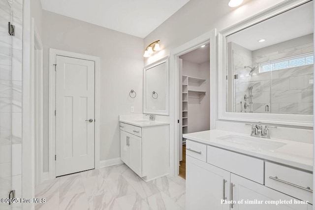 bathroom with marble finish floor, two vanities, a sink, and a shower stall