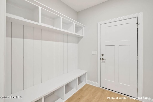 mudroom featuring wood finished floors and baseboards