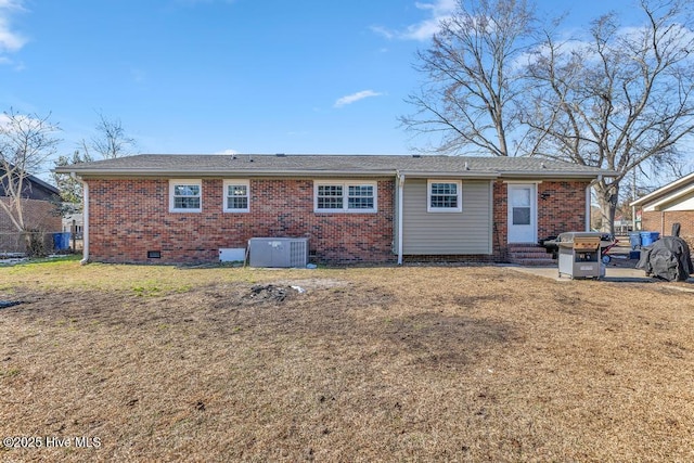 rear view of property with a patio, a yard, and central AC unit