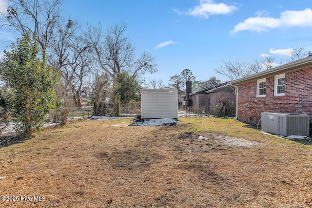 view of yard with cooling unit and a storage shed