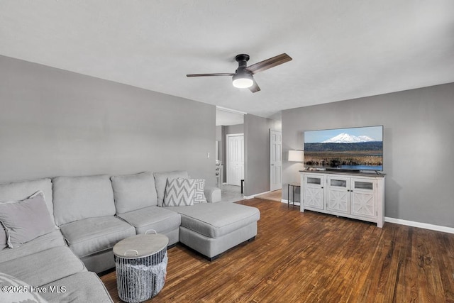 living room with dark wood-type flooring and ceiling fan