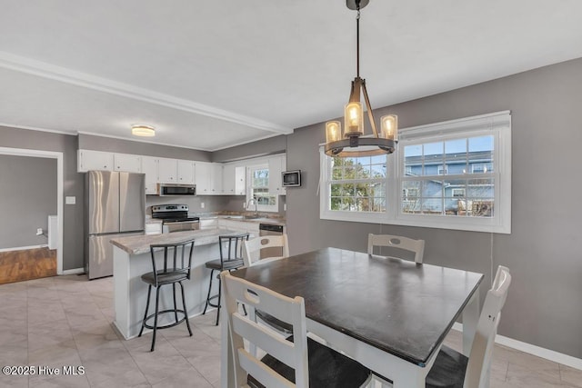 dining room with sink and a chandelier