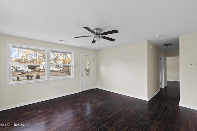 spare room featuring ceiling fan and dark hardwood / wood-style floors