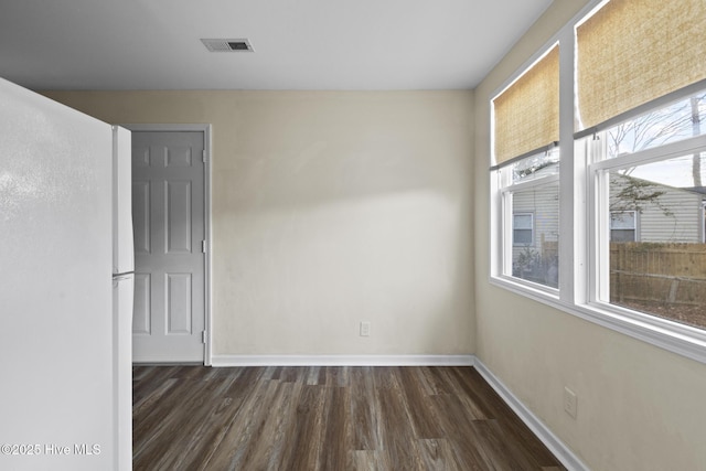 spare room featuring dark hardwood / wood-style floors