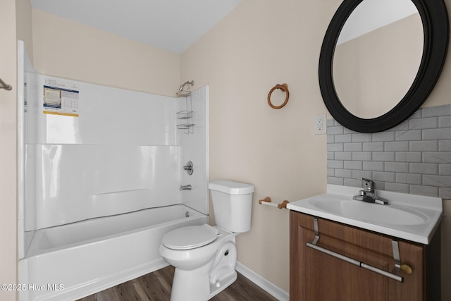 full bathroom featuring washtub / shower combination, backsplash, hardwood / wood-style floors, vanity, and toilet