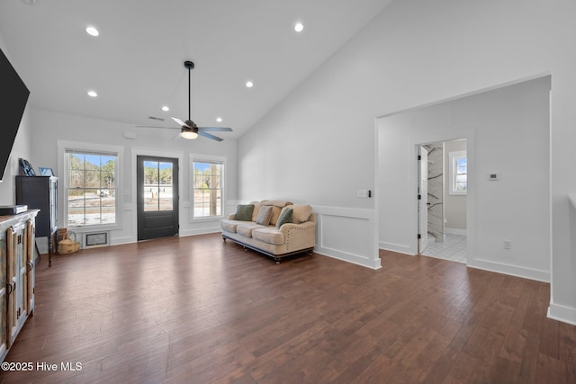 living room with dark wood-type flooring, high vaulted ceiling, and ceiling fan