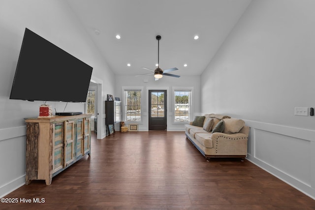 living room with dark wood-type flooring, high vaulted ceiling, and ceiling fan