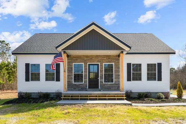 view of front of home with a porch and roof with shingles