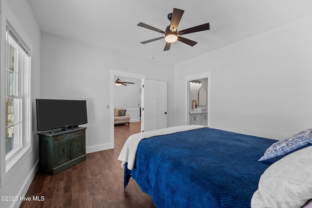 bedroom with ensuite bathroom, dark wood-type flooring, and ceiling fan