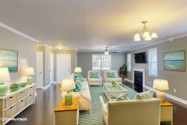 living room featuring crown molding, plenty of natural light, dark hardwood / wood-style floors, and ceiling fan with notable chandelier