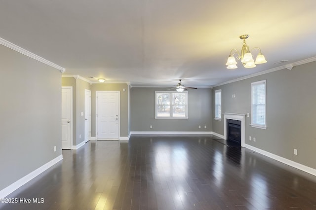 unfurnished living room with ornamental molding, plenty of natural light, ceiling fan with notable chandelier, and dark hardwood / wood-style flooring