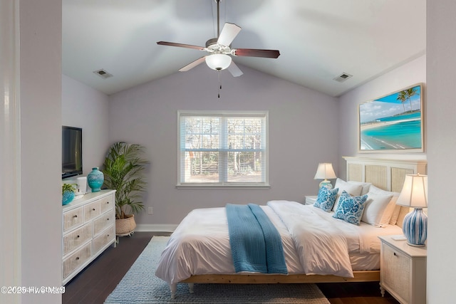 bedroom with dark wood-type flooring, vaulted ceiling, and ceiling fan