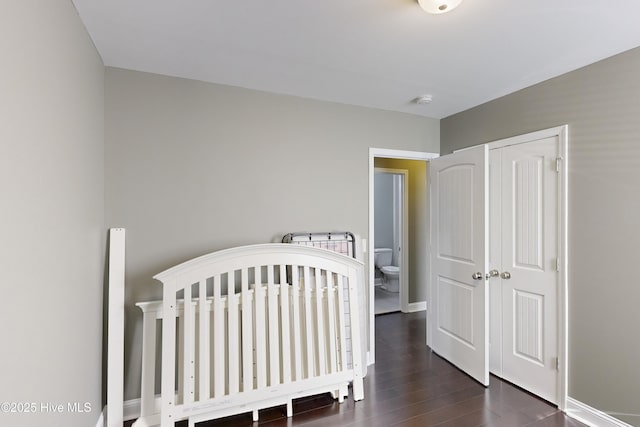 bedroom with a closet and dark hardwood / wood-style floors