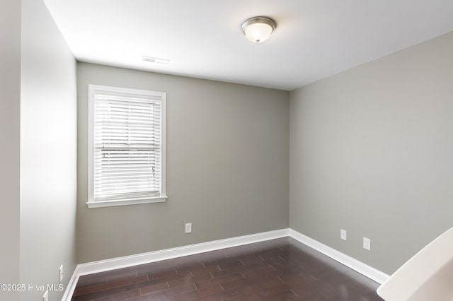 spare room featuring dark hardwood / wood-style flooring